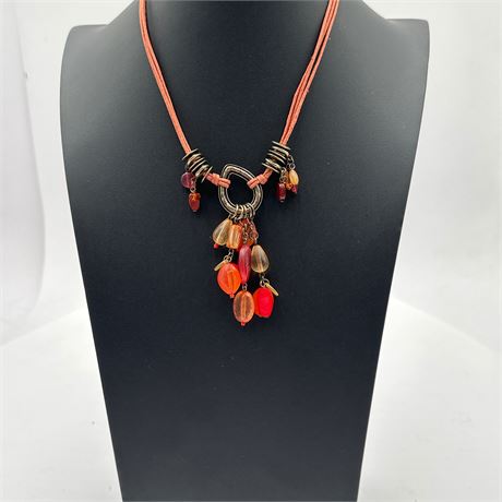 Costume Necklace with Cord Strands, Metal Ring Centerpiece, and Resin Bead